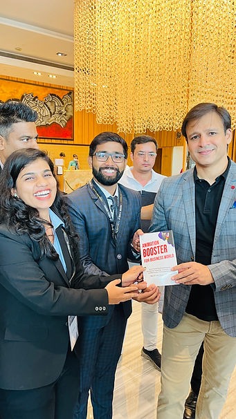 Founders presenting their book to Vivek Oberoi